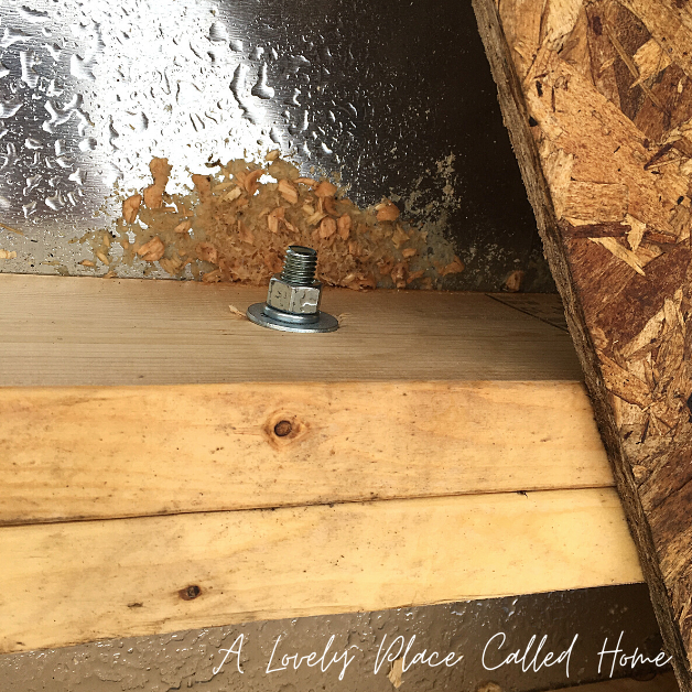 picture of bolt securing the pieces together -how to build a tiny house floor on a camper trailer frame   - a lovely place called home 